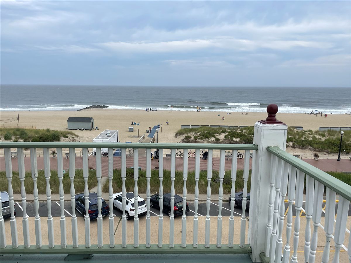 Ocean and beach view over the white Victorian railing at the Laingdon Hotel, Ocean Grove
