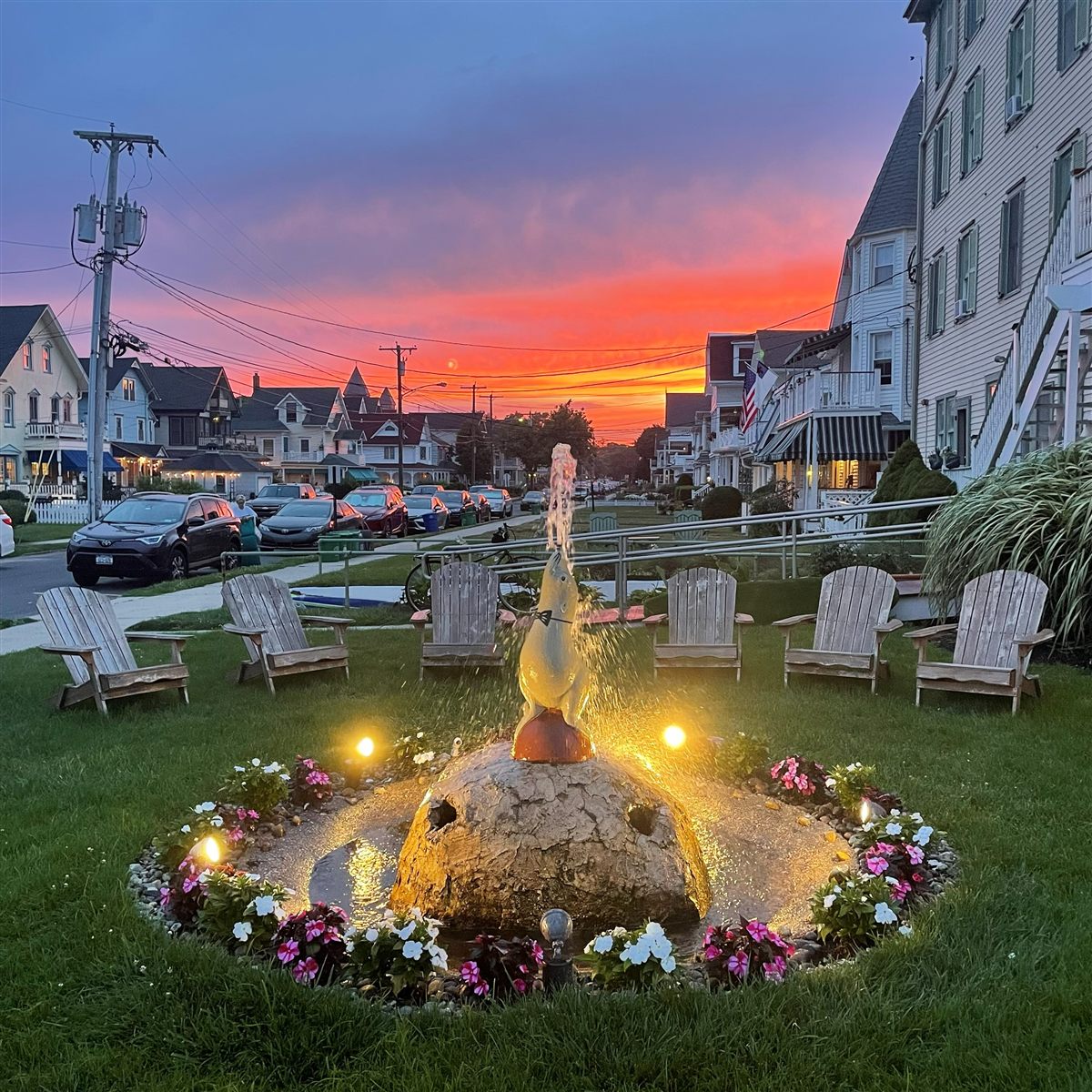 Lit fountain and Ocean Avenue at sunset outside the Laingdon Hotel