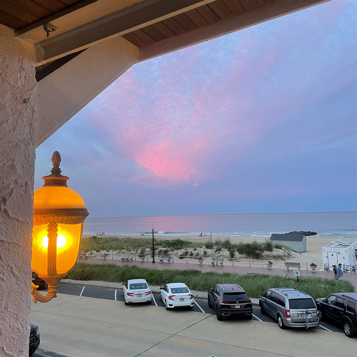 Sunset over the Ocean Grove beach seen from the Laingdon Hotel porch, a setting for a beach wedding ceremony