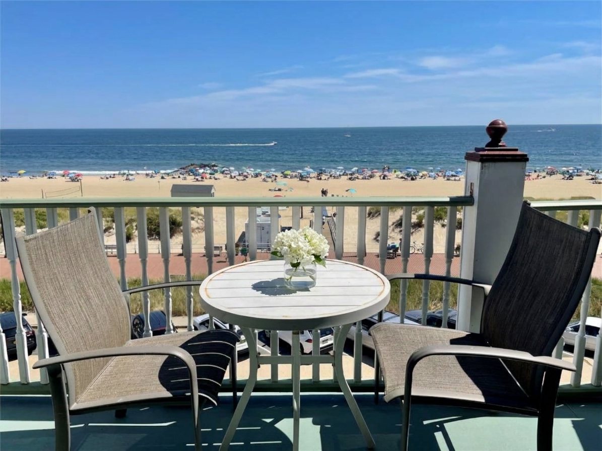 Sunny oceanfront balcony with white hydrangeas overlooking the Ocean Grove beach, near Asbury Park